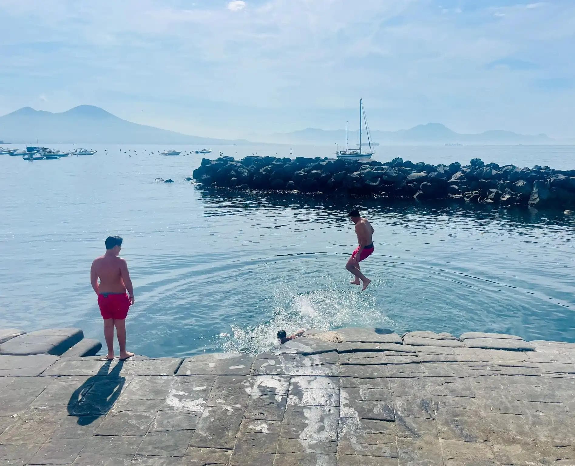 boys jumping in the sea