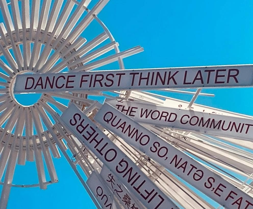 a sign reading "Dance first think later"